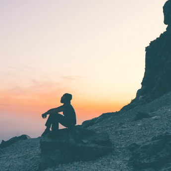 Nomad Soul - niKk Green sitting on a mountain top in Uttarakhand, India